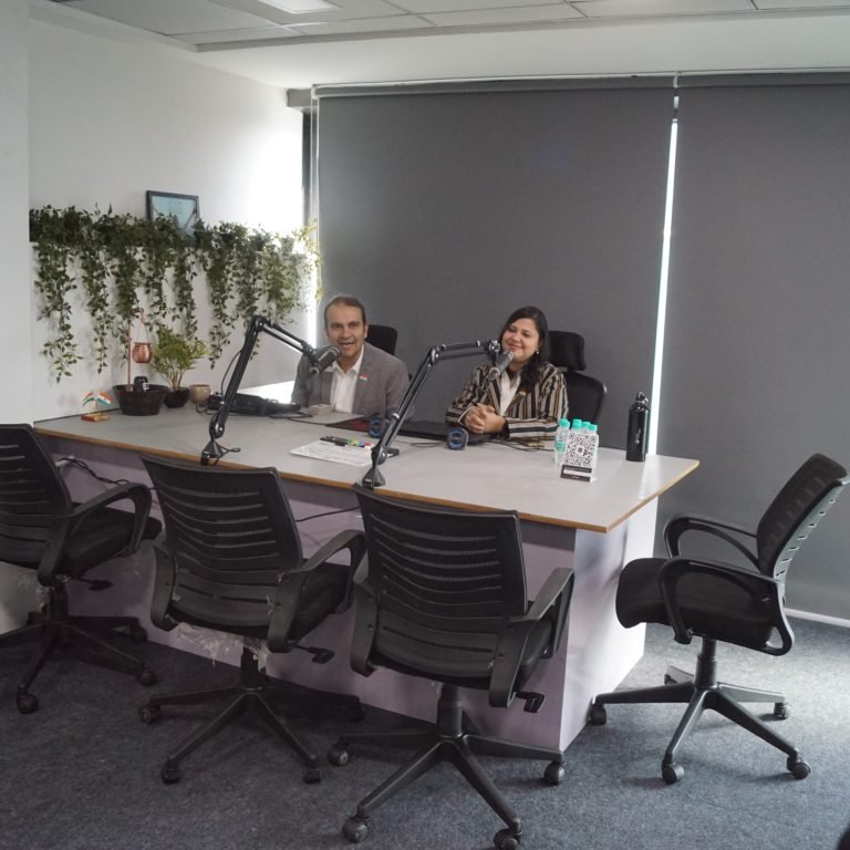 The owner of the digital marketing agency records a broadcast in the office.